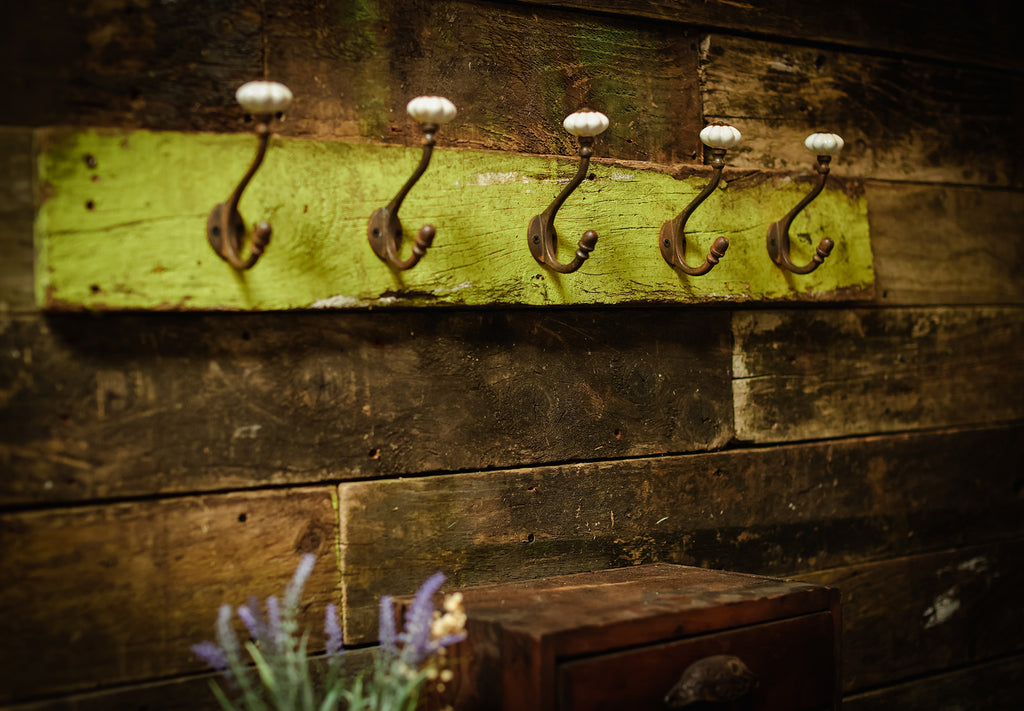 Vintage coat hooks on greed wood