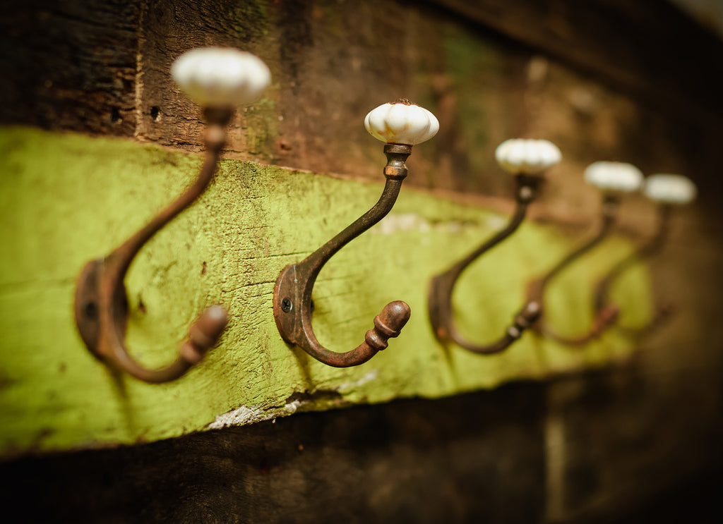 Vintage coat hooks on greed wood